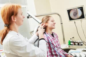 Pediatric ENT doctor checking the ear of a patient experiencing hearing loss in Birmingham